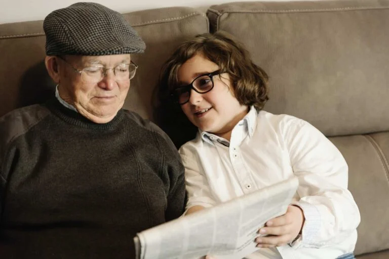 grandfather and grandson reading the news